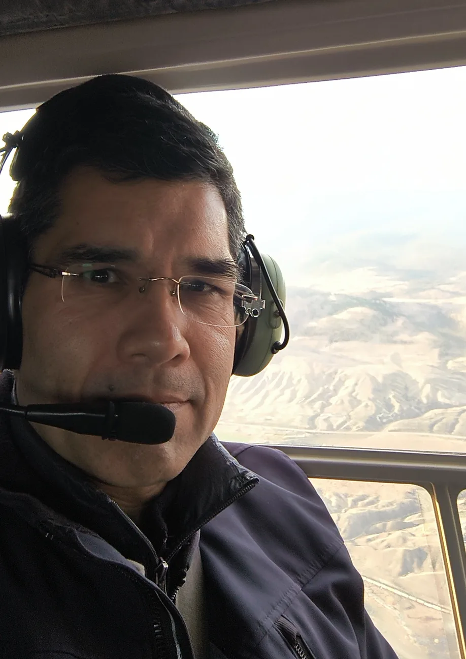 Clayton Smith in a helicopter during field work